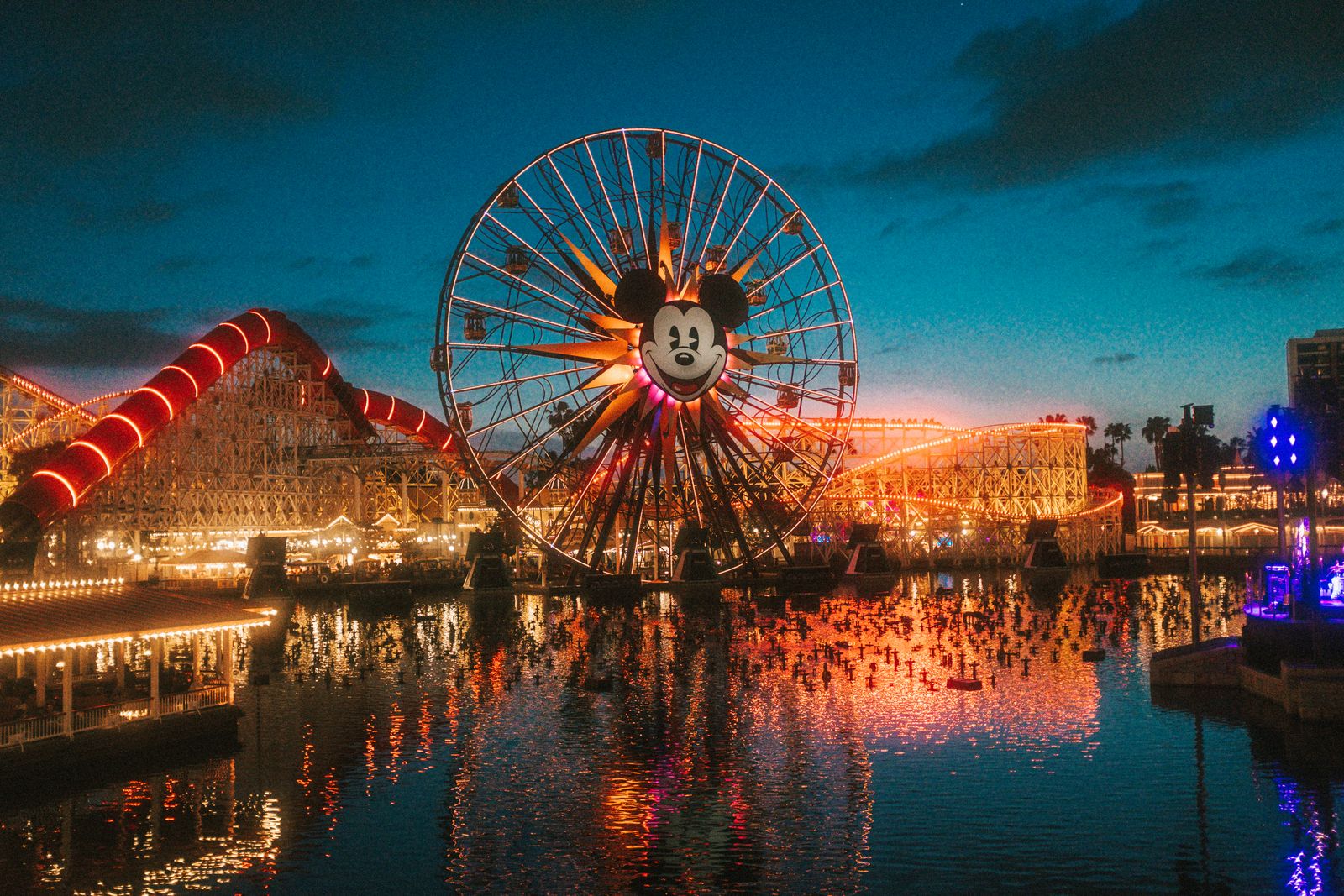 Pixar Pier and the Incredicoaster lit up at sunset at the Disneyland Resort in Anaheim